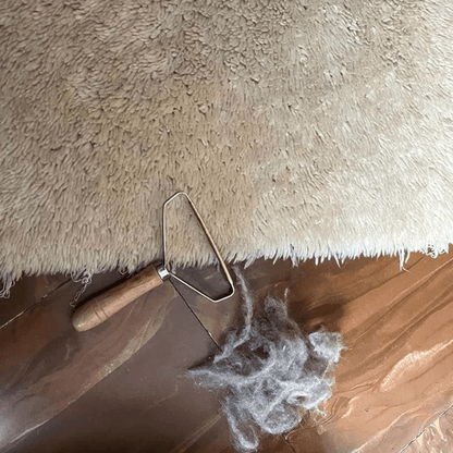 Premium Remover lifting pet fur from a couch cushion